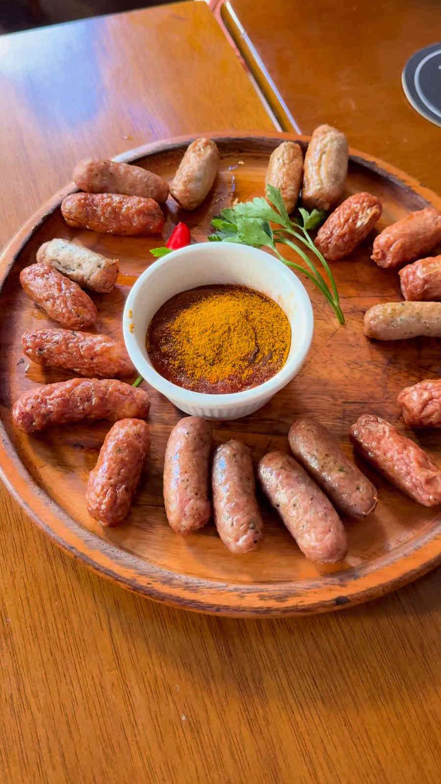 An assortment of small German sausages with curry sauce at Adega do Pimenta