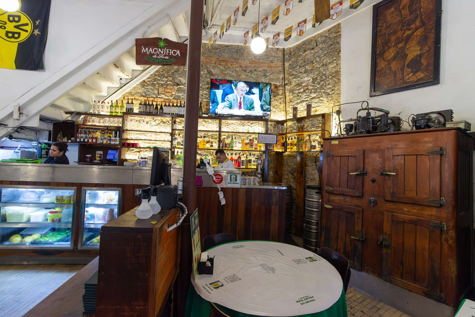 The bar counter and historic wooden furniture at Bar Brasil