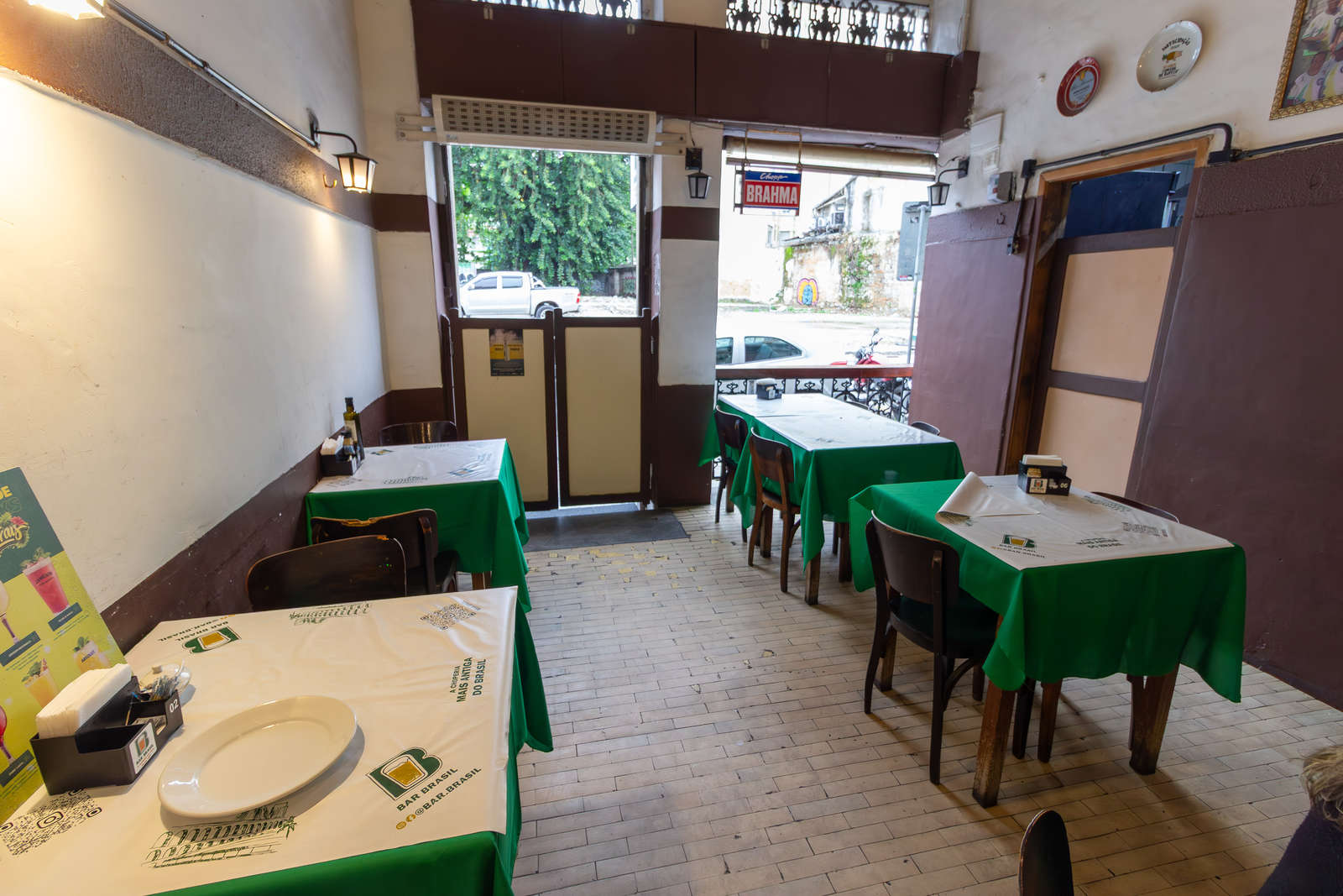 Tables beside the open frontage of Bar Brasil in Lapa