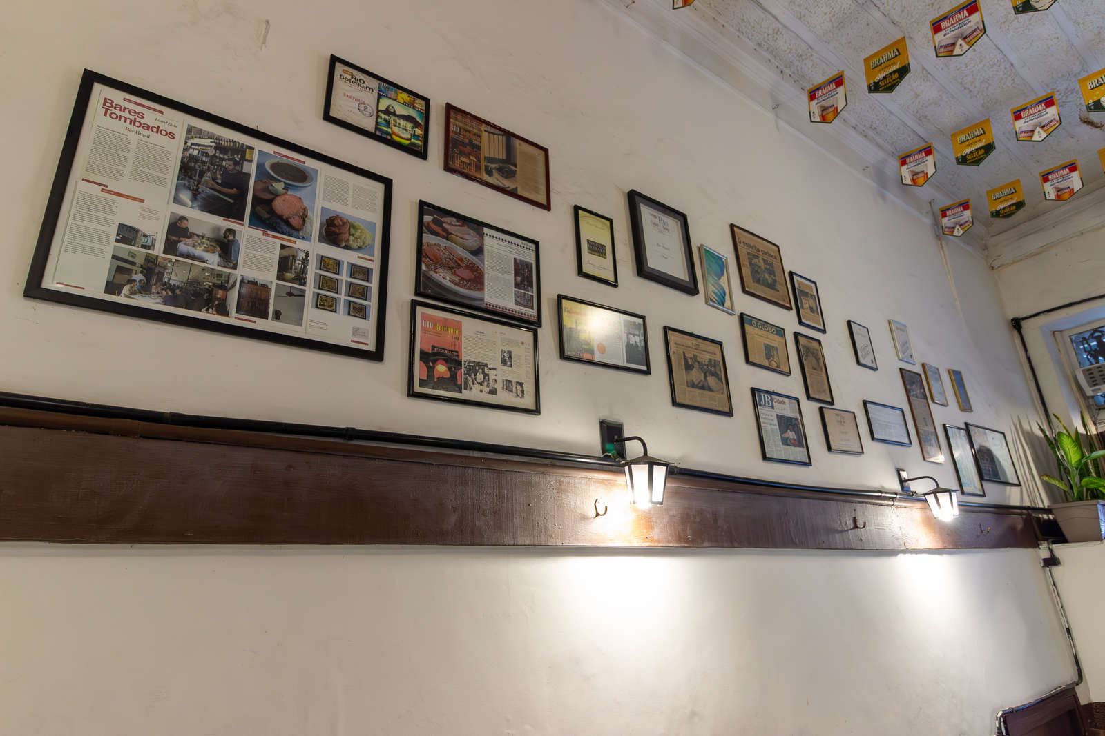 Newspaper clippings and awards on the wall at Bar Brasil