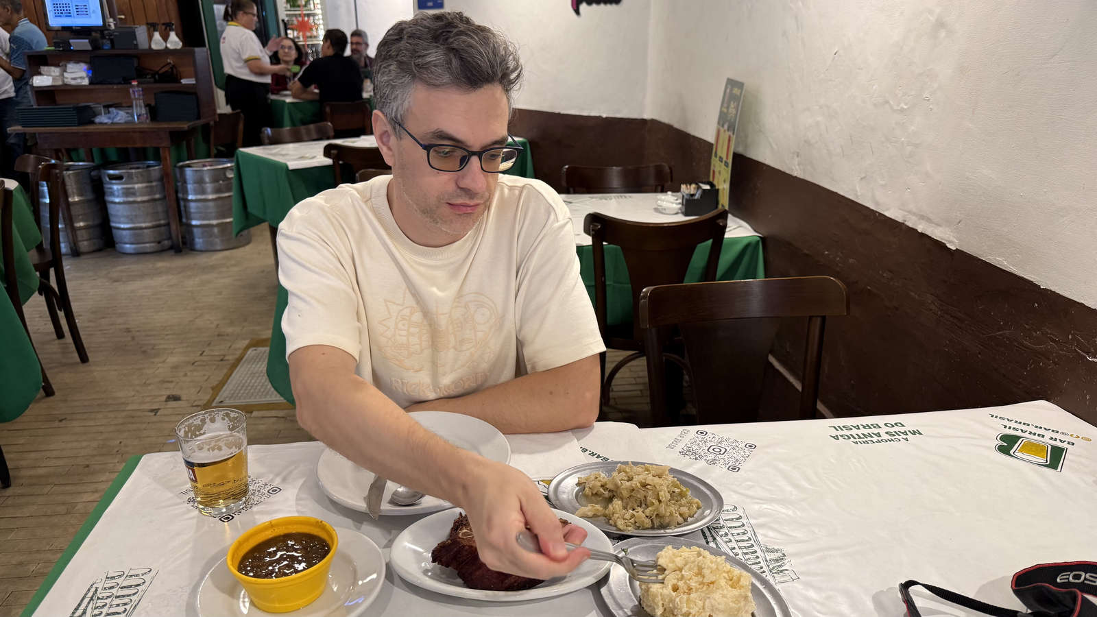 The author trying smoked kassler and side dishes at Bar Brasil