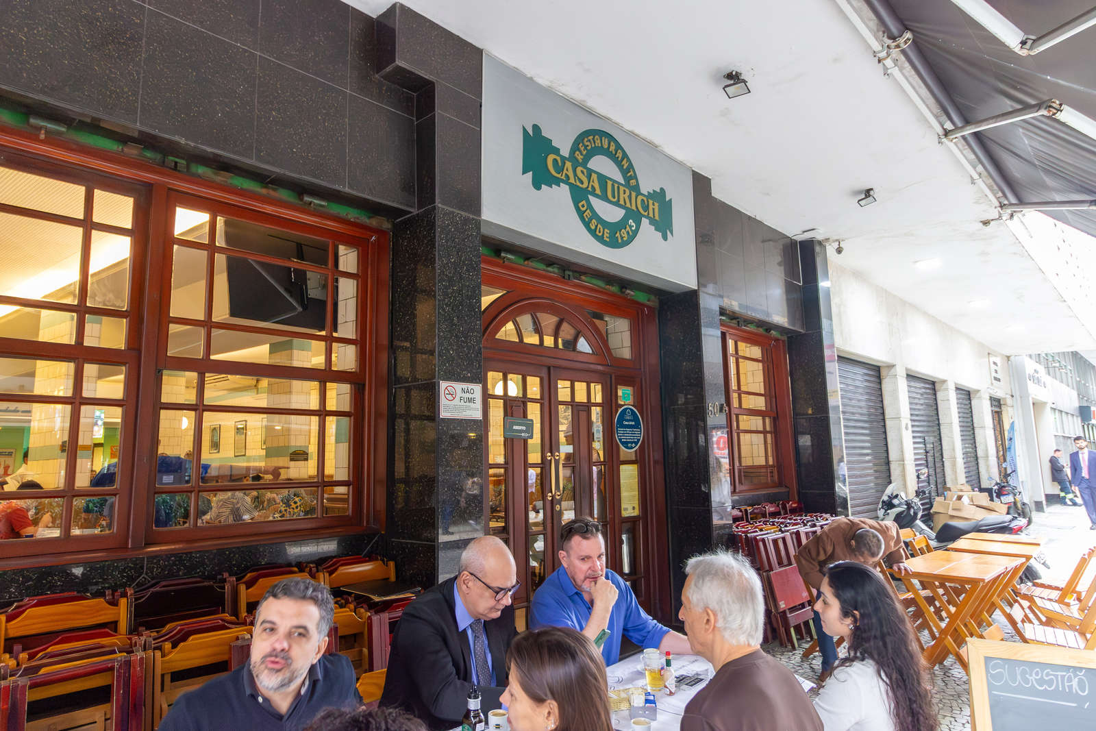 The facade and sidewalk tables at Casa Urich in central Rio