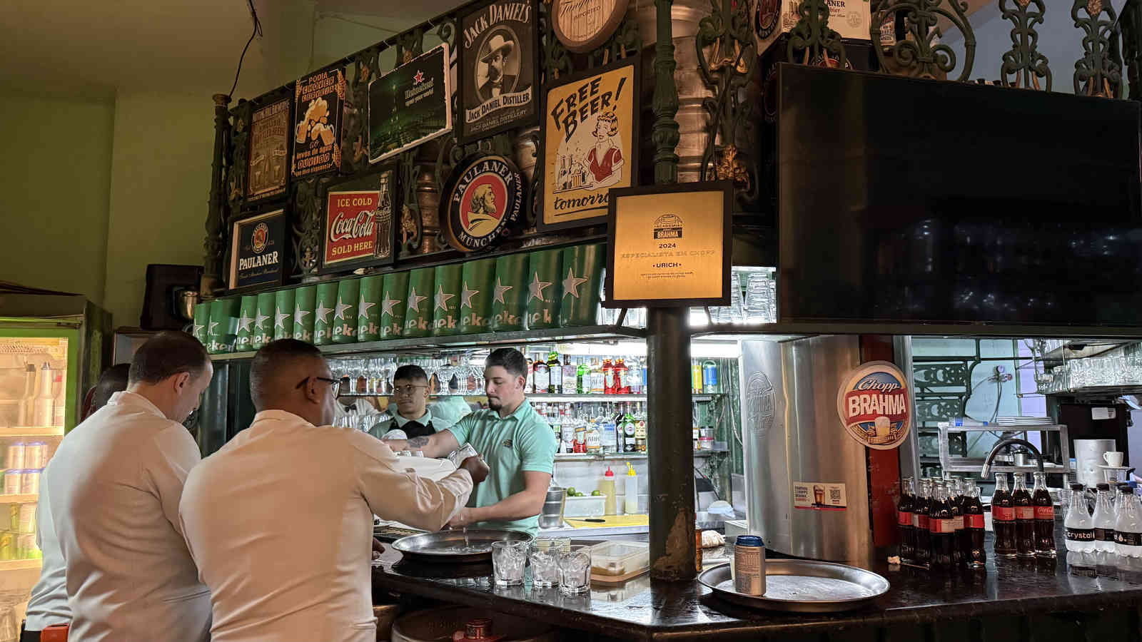 The bar counter at Casa Urich with vintage beer signs