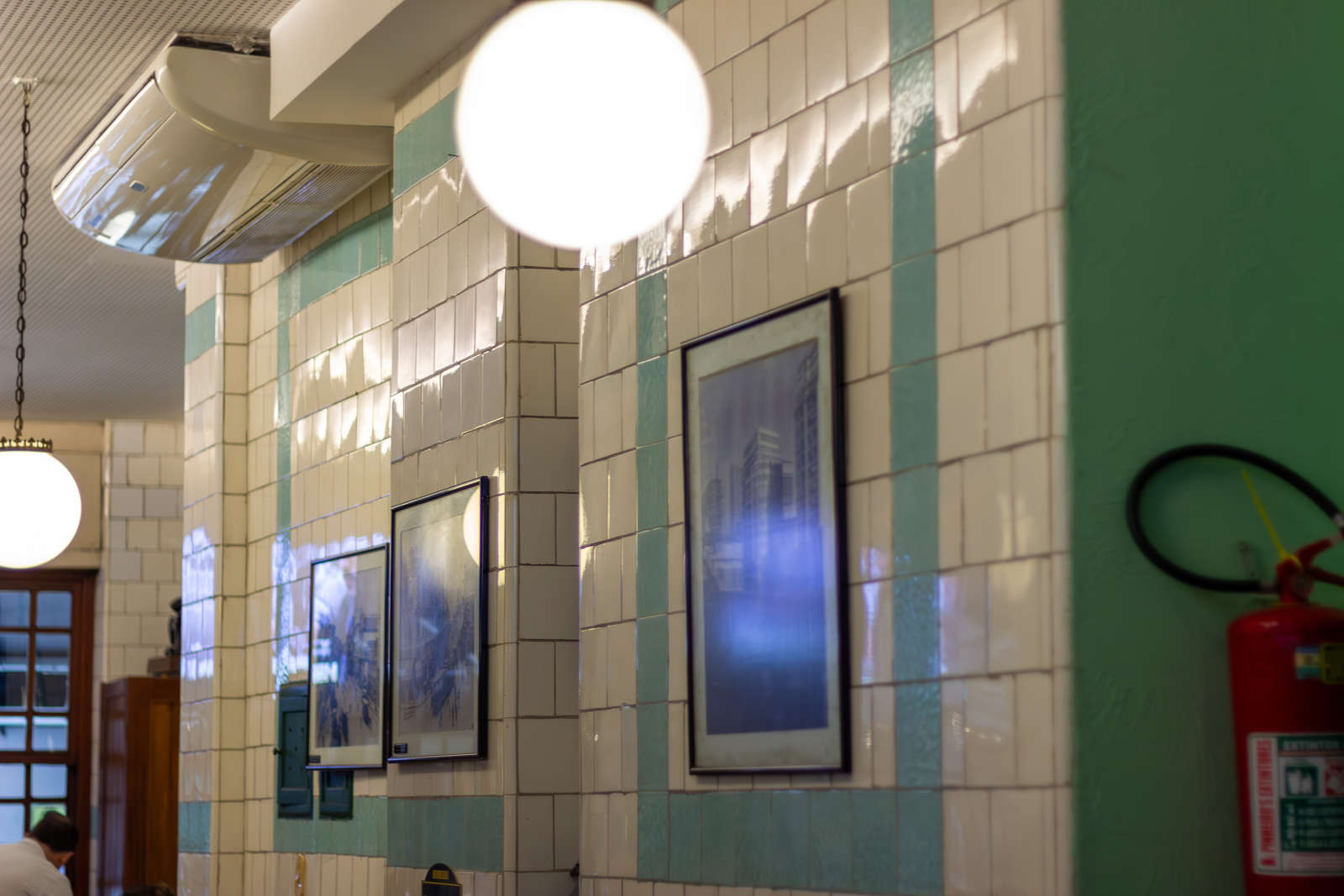 Historic white and green tiles and old photographs at Casa Urich