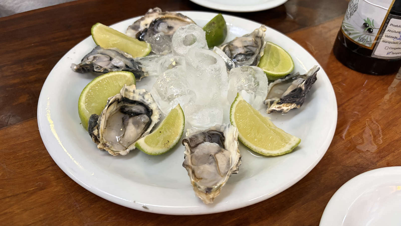 Small plates and seafood on the counter at Adega Pérola