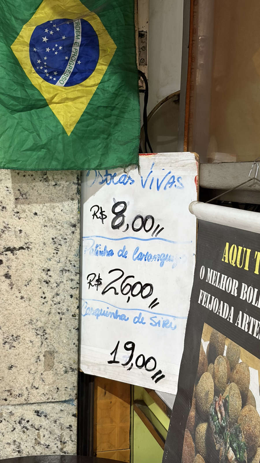 A vertical view of the counter and seating at Britânia Rio-Lanches