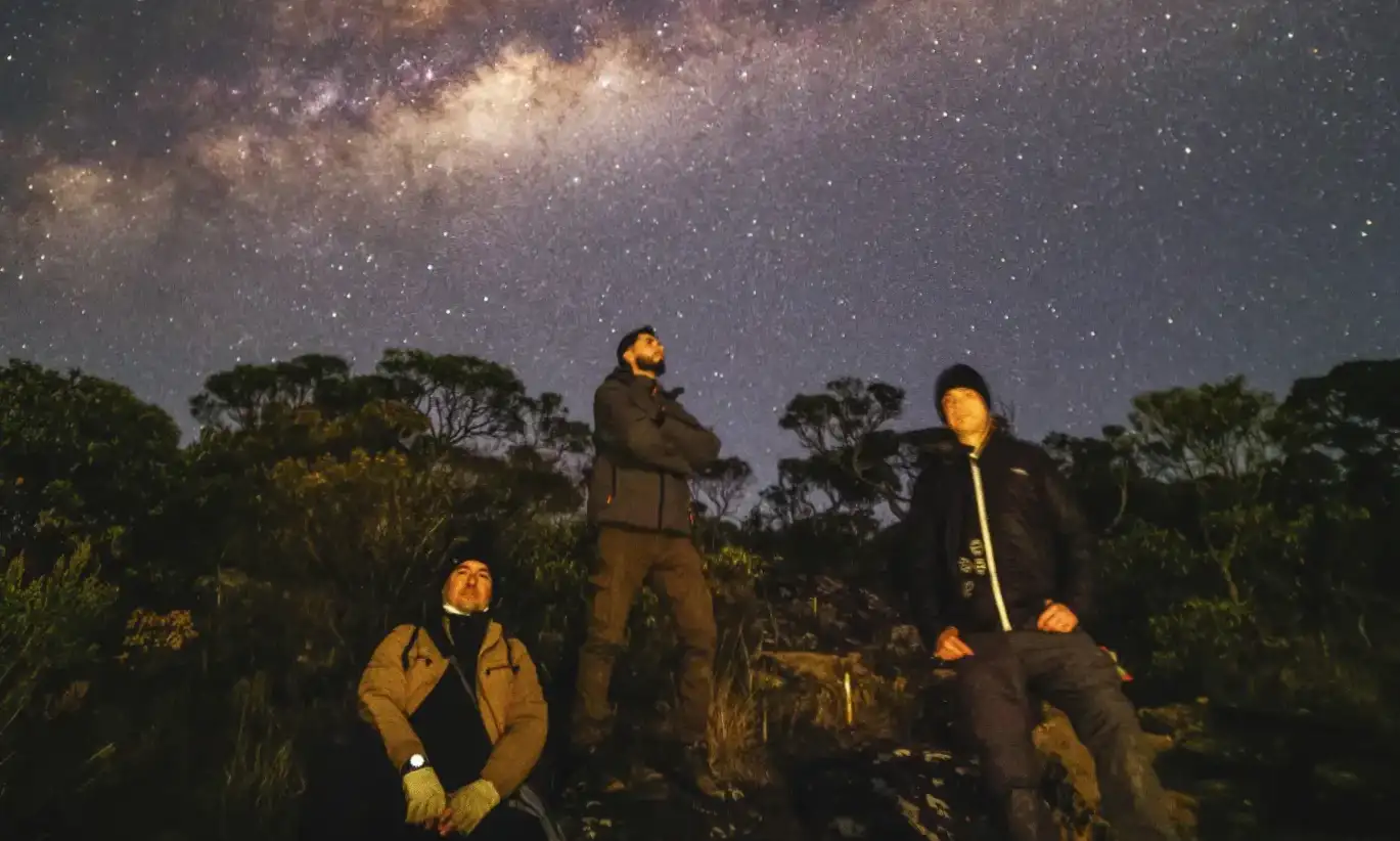 Travelers observing the Milky Way during a night excursion