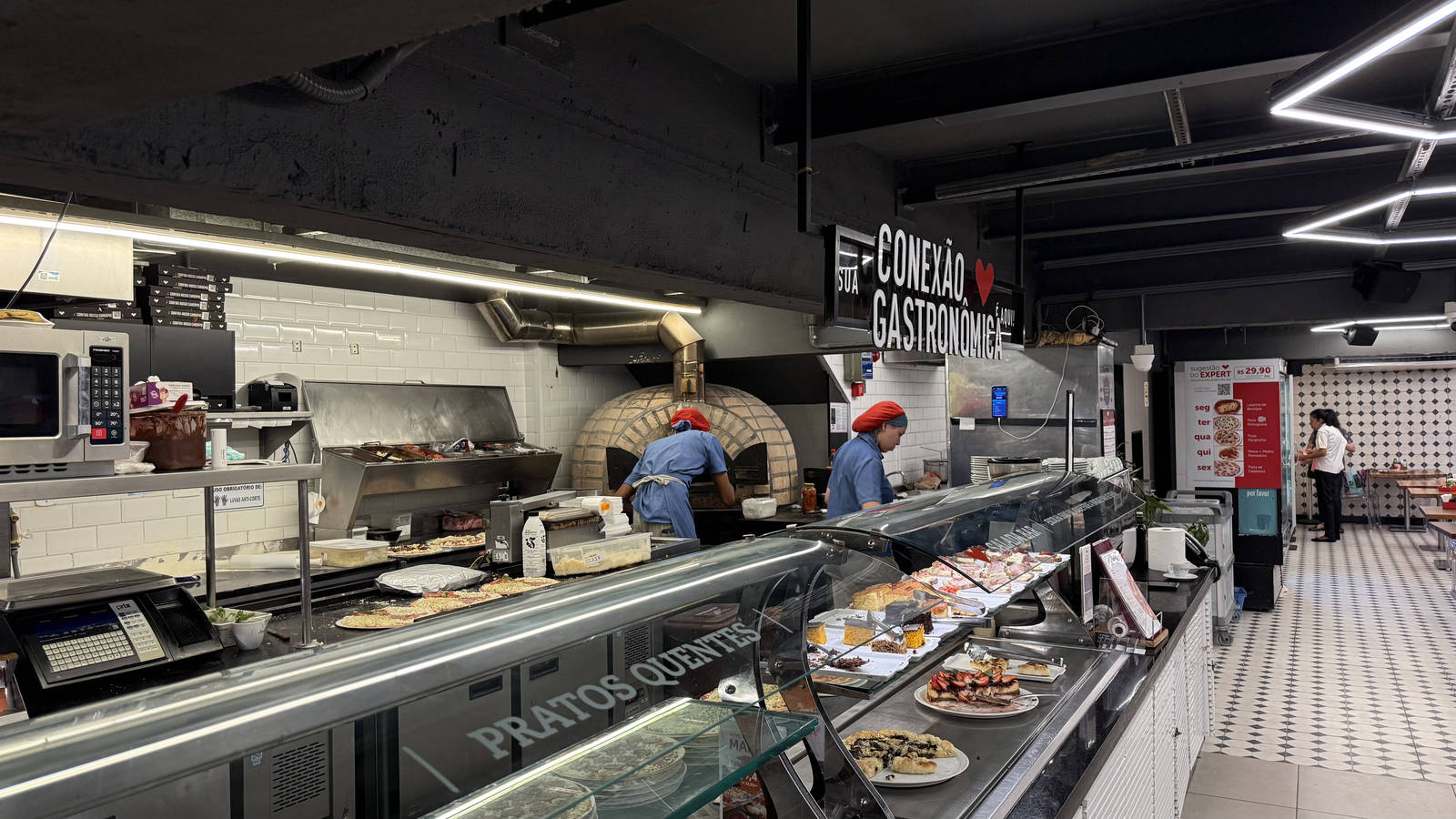 The prepared-food counter and kitchen area at Zona Sul