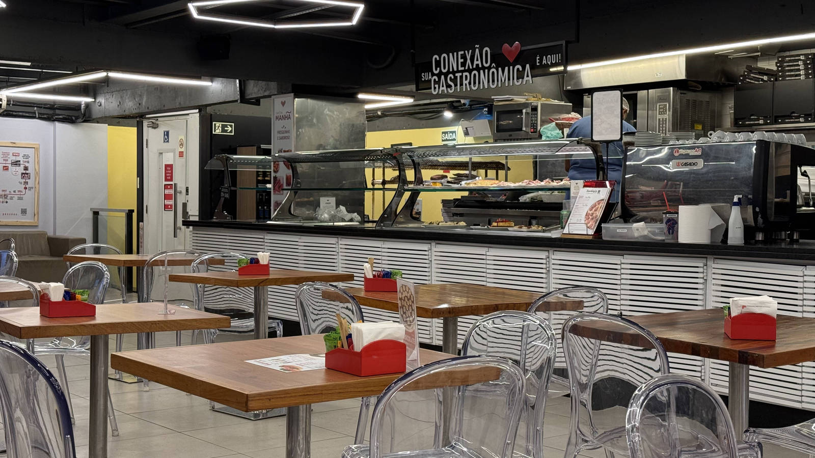 Tables beside the prepared-food counter at Zona Sul