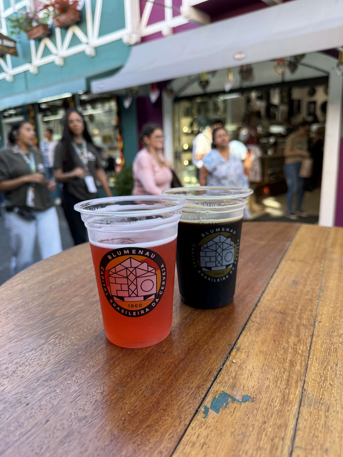 Two local beers in cups decorated with Blumenau branding
