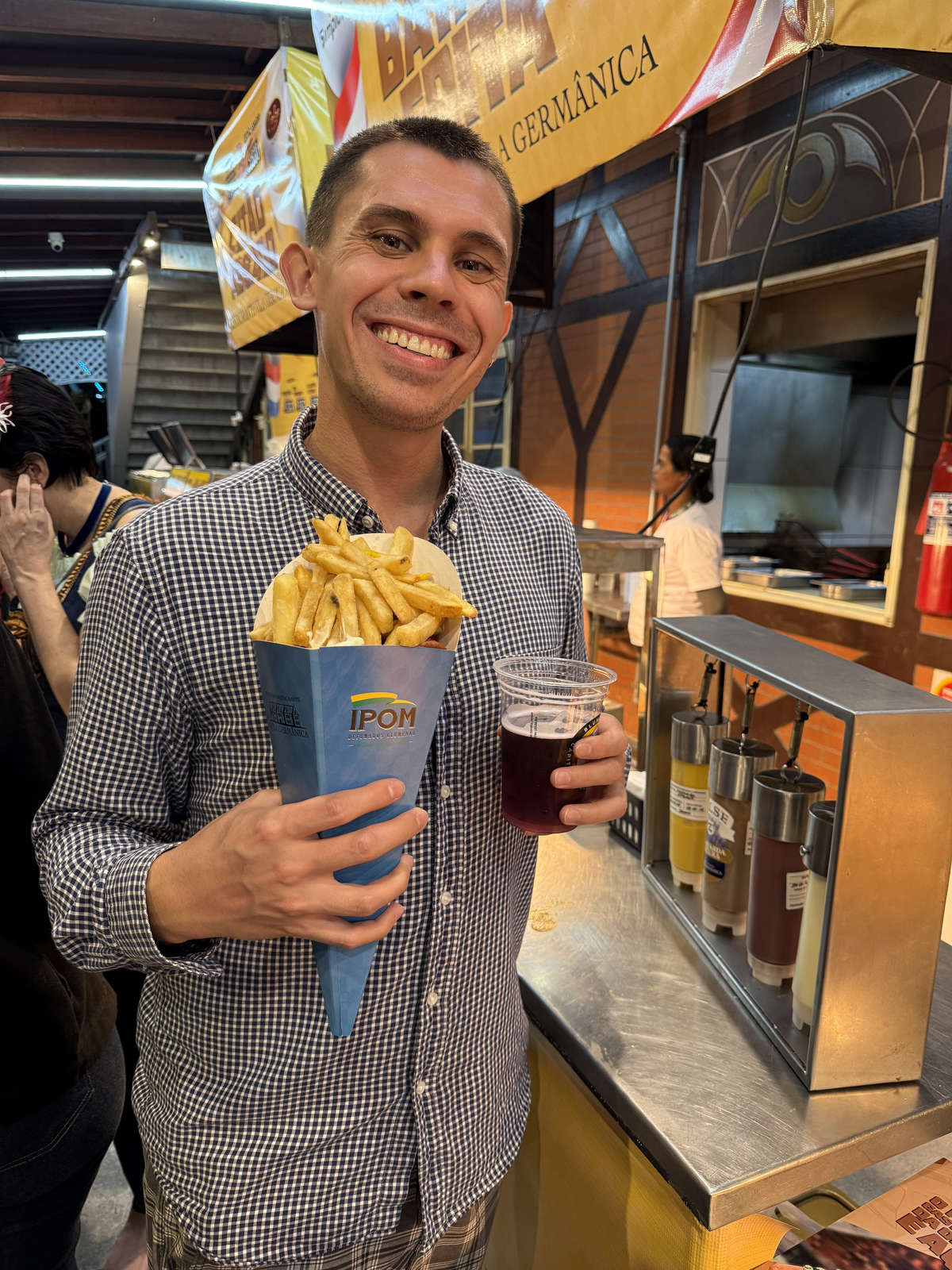 Fries and beer inside an Oktoberfest Blumenau pavilion