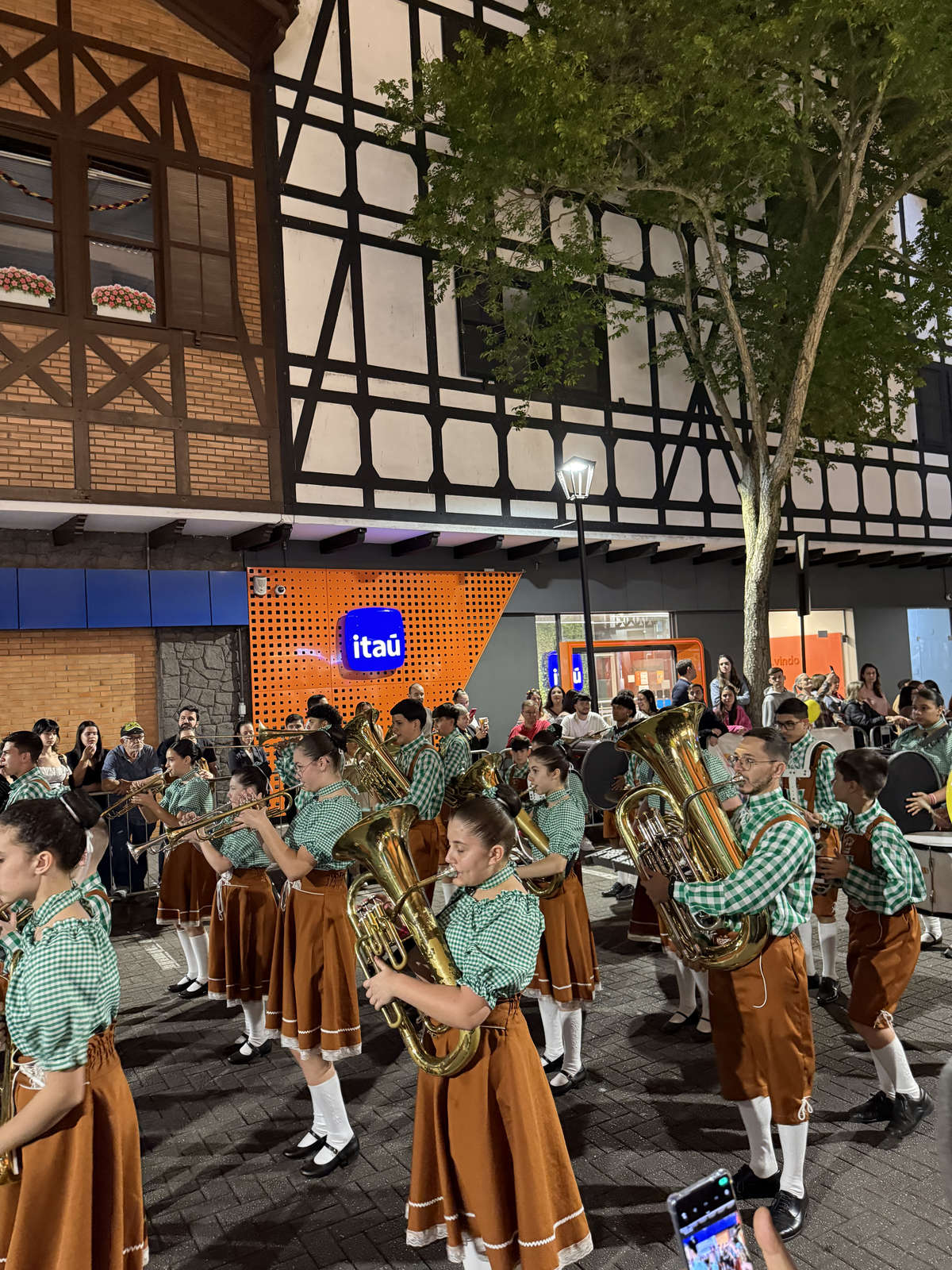 A brass band in the evening Oktoberfest Blumenau parade on Rua XV de Novembro