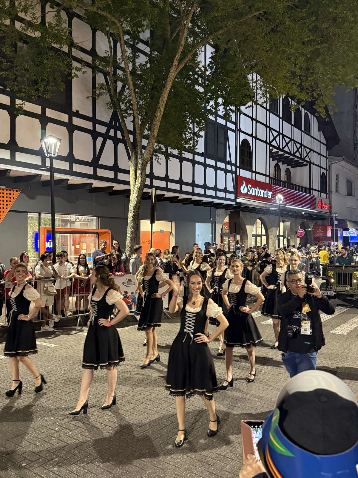 A dance group in black dirndls in the Oktoberfest Blumenau parade