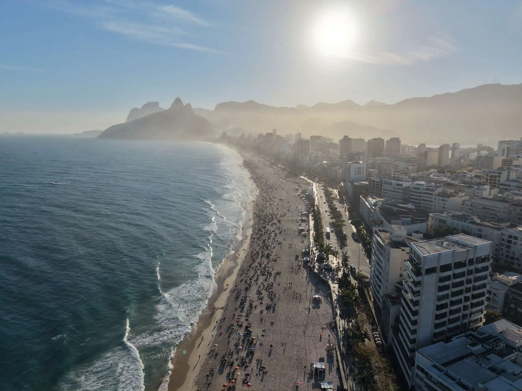 An aerial view of Ipanema Beach, the ocean, and Dois Irmãos